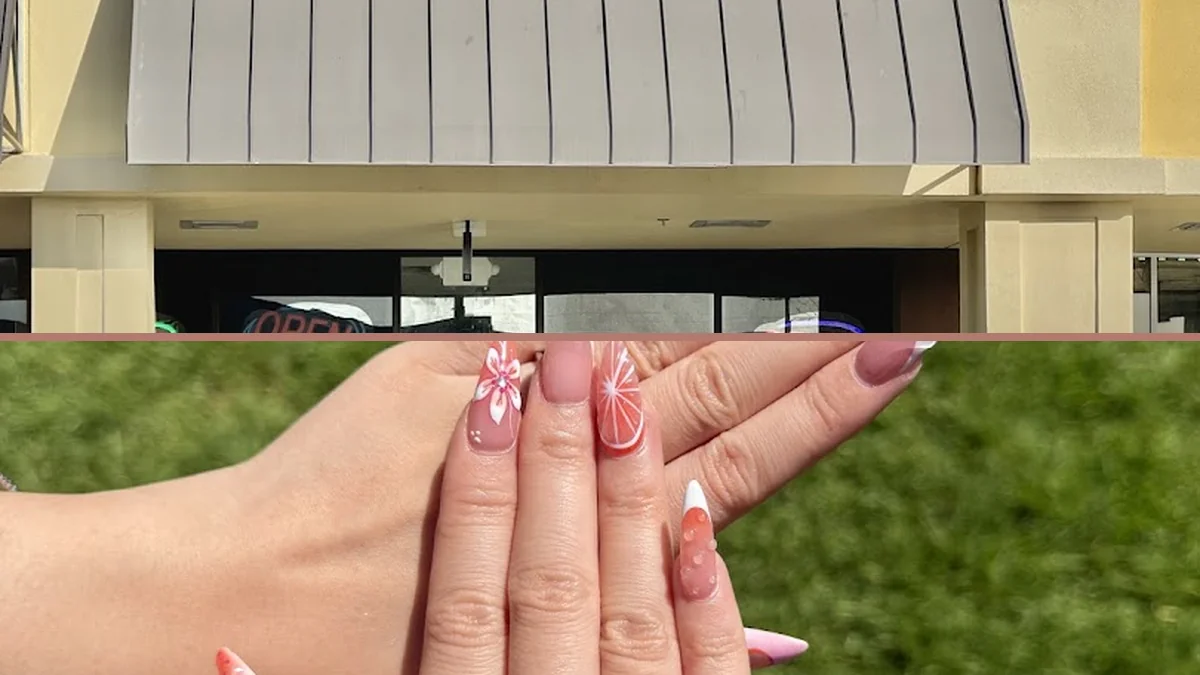 Nail technician shaping acrylic nails at a salon table.